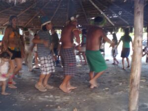 Indigene und Gäste tanzen in der Aldeia Maracana eine traditionellen Rundtanz